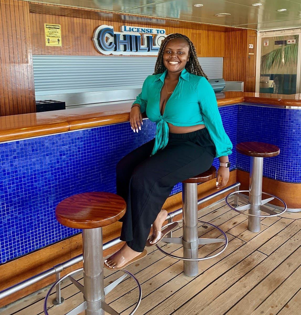 Blogger Christina Jane sitting at the bar on the cruise ship. 