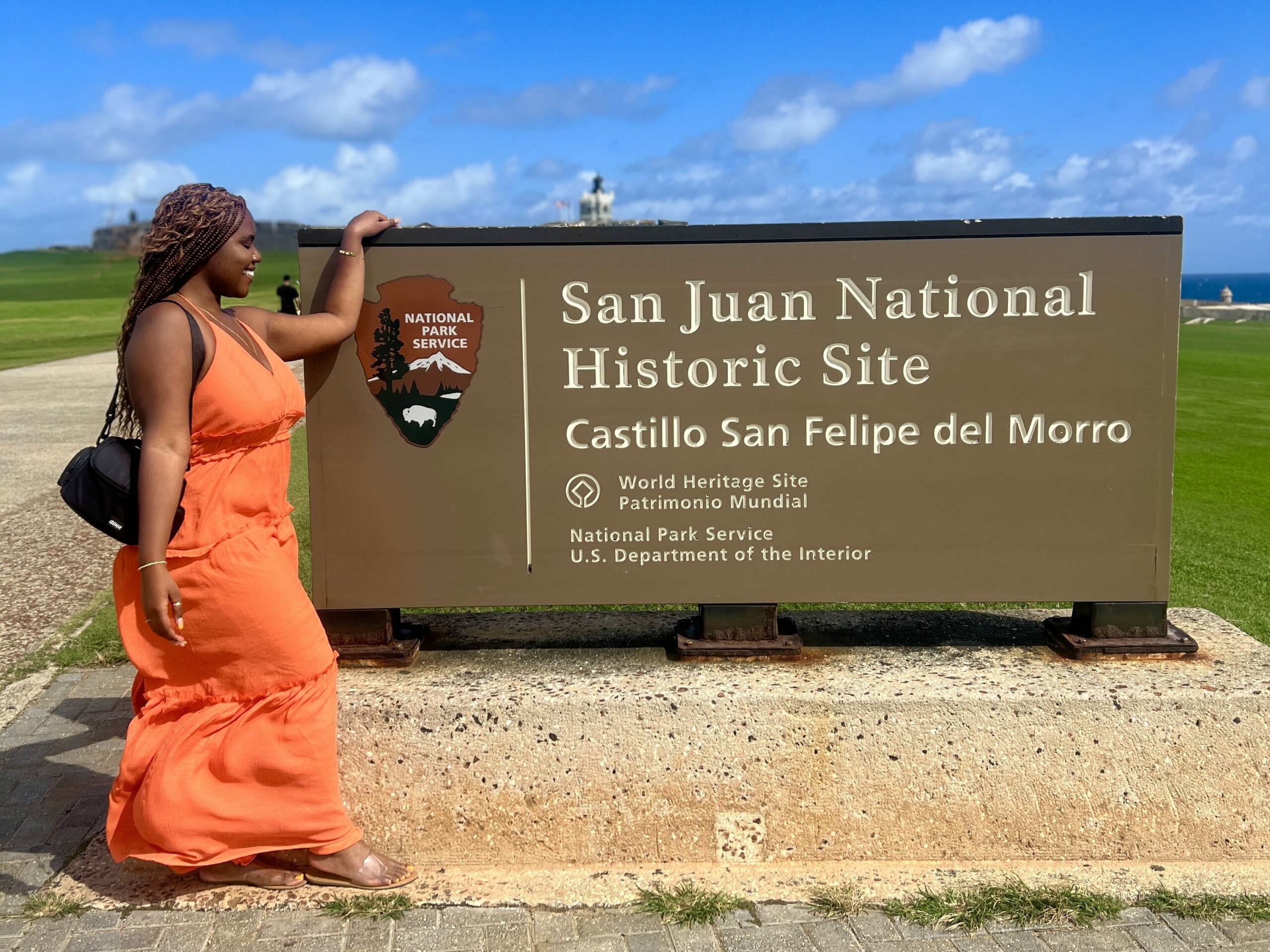 Christina Jane standing in front of the Castillo San Felipe del Morro sign 
